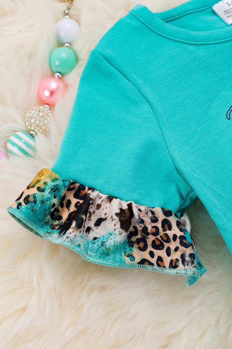 JUST A GIRL WHO LOVES.. AQUA BABY ONESIE.