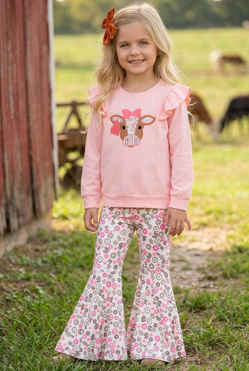 Cow applique on pink sweatshirt with floral bell bottoms.