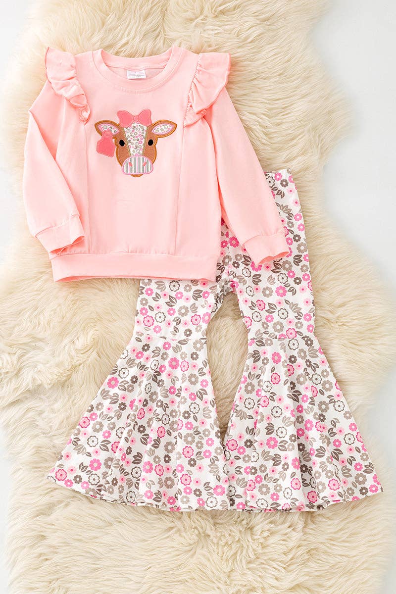Cow applique on pink sweatshirt with floral bell bottoms.