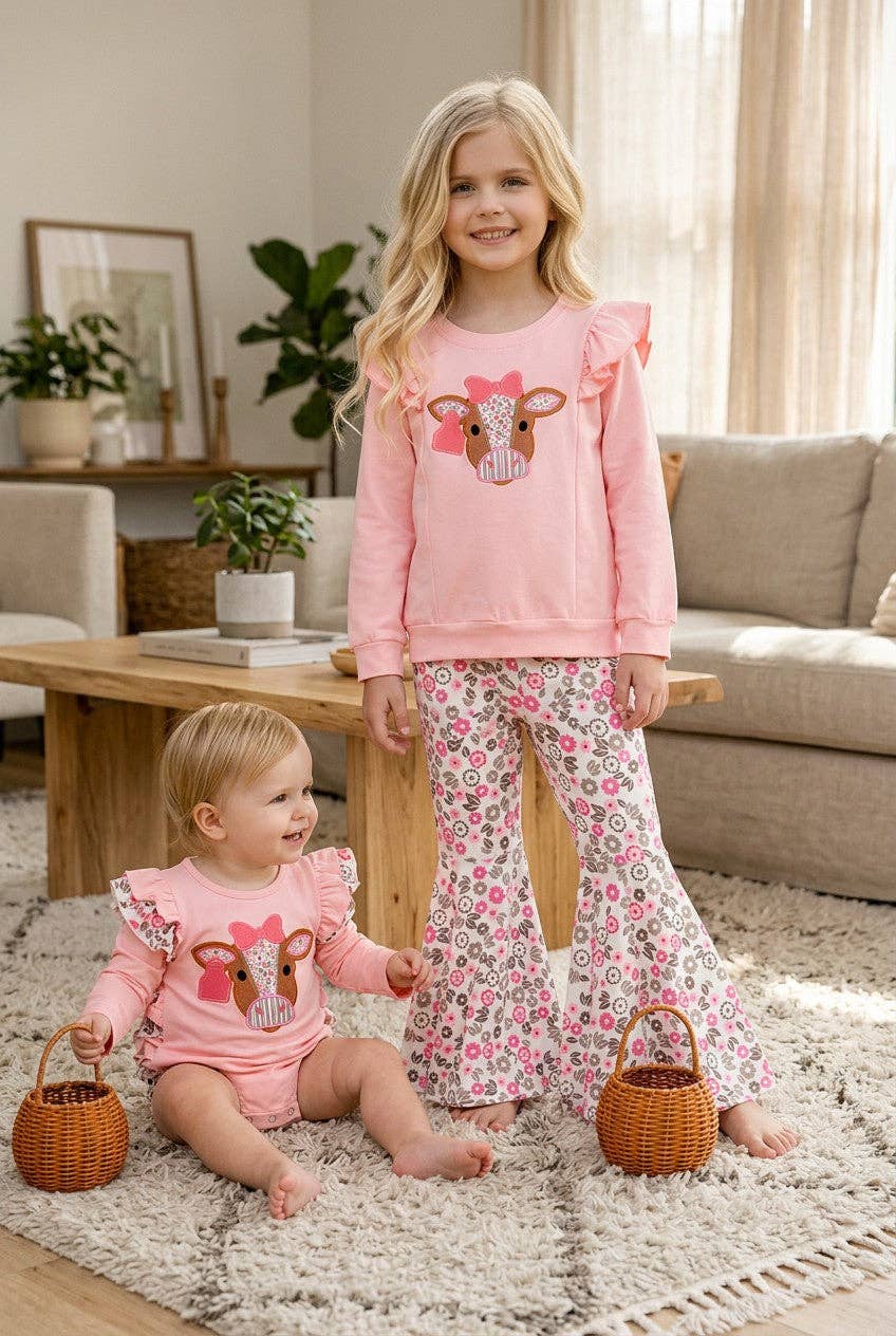 Cow applique on pink sweatshirt with floral bell bottoms.