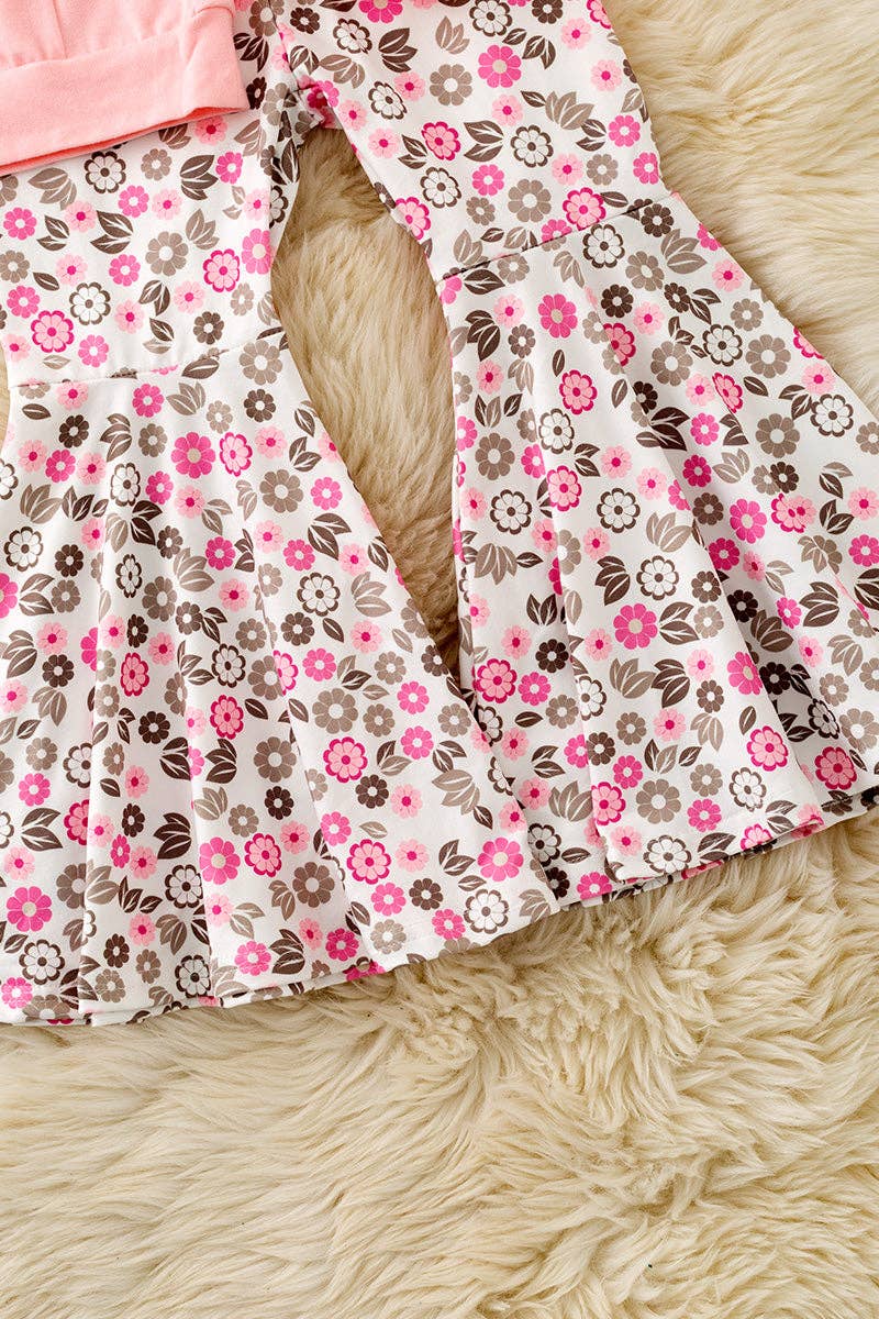 Cow applique on pink sweatshirt with floral bell bottoms.