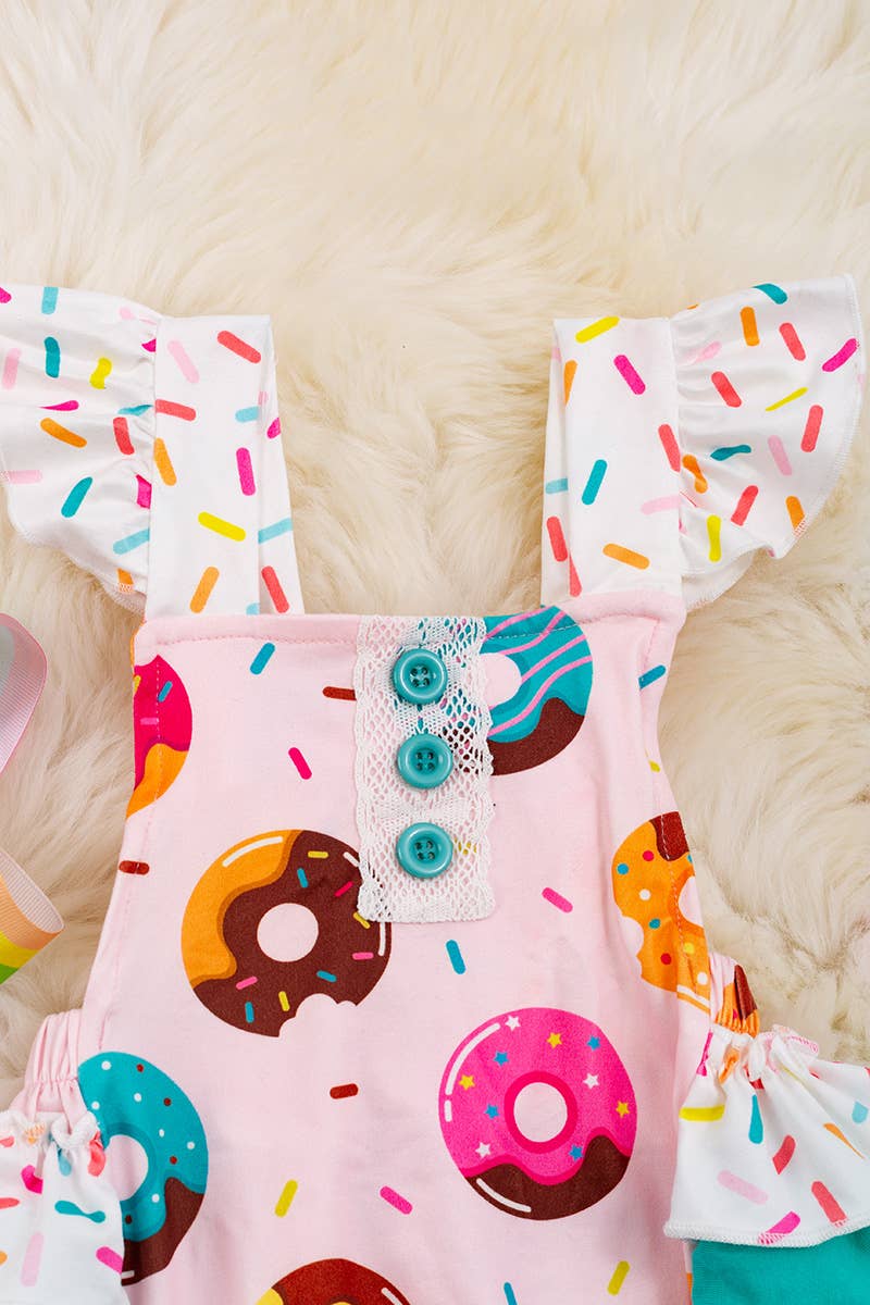 MULTI- PRINTED DONUT ON PINK BABY ONESIE.